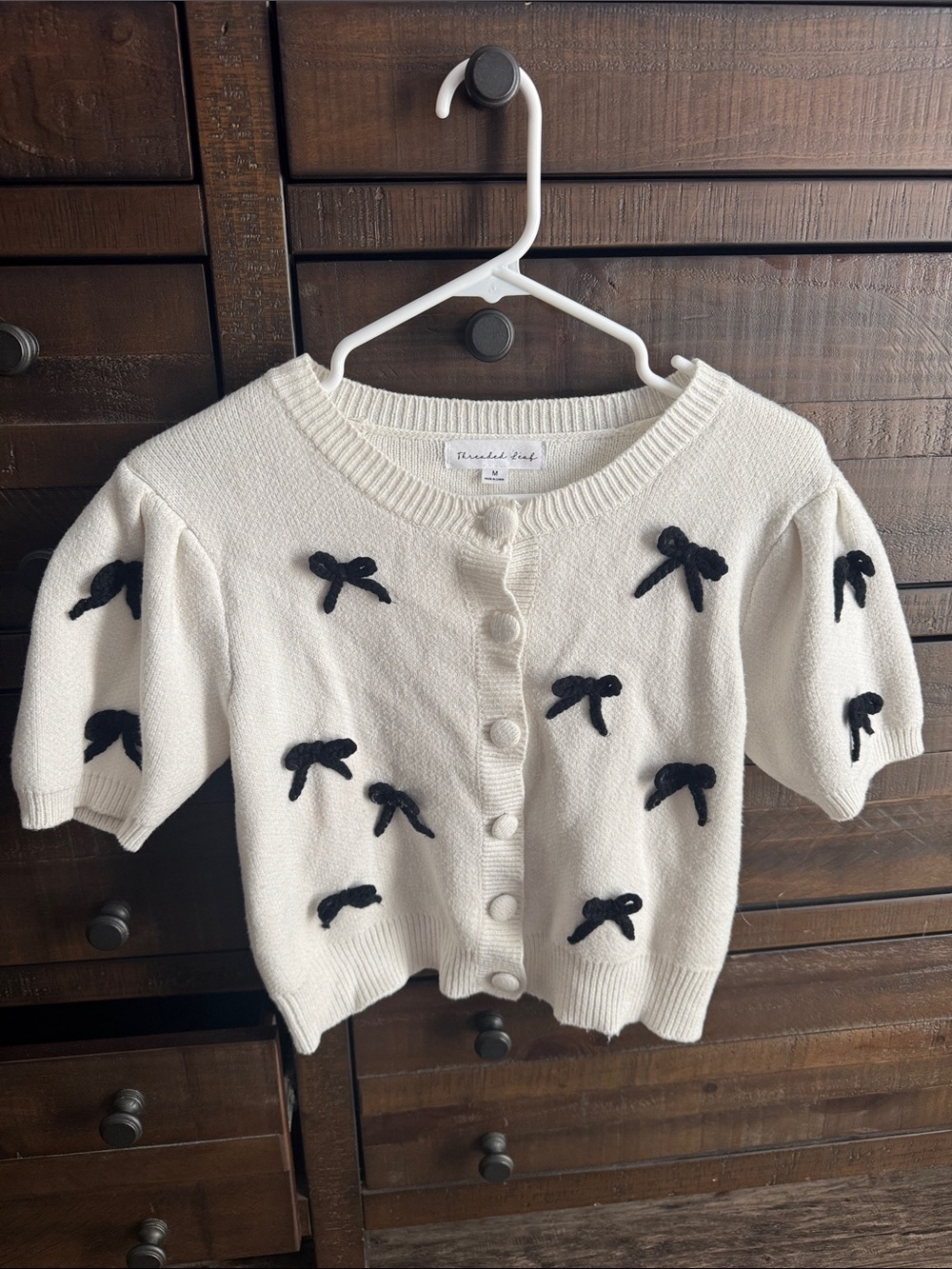 Threaded Leaf Cream Knit Cardigan with Black Bow Accents